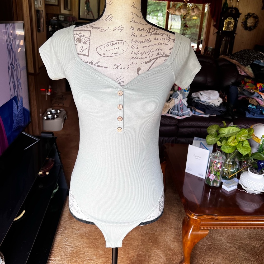 Woman’s gaze light green bodysuit